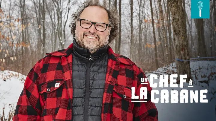 Image officielle de l'émission Un chef à la cabane : Martin Picard, en chemise à carreaux, sourit dans une érablière enneigée